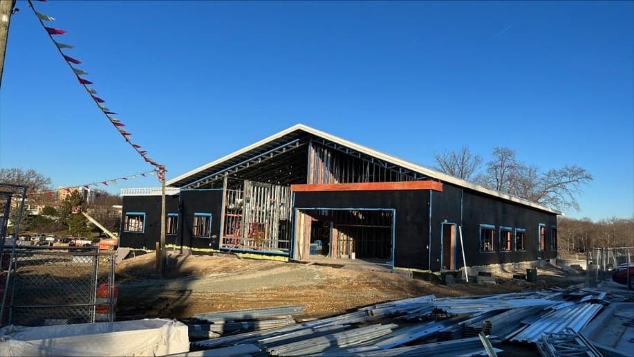 Commercial building exterior under construction with weather barrier